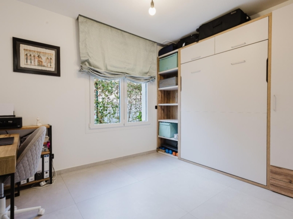 Home office corner with a desk and printer on the left, and a tall white wardrobe with shelves on the right.