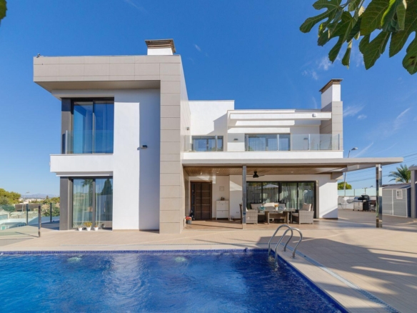 Modern white two-story house with glass balconies, outdoor seating, and a blue swimming pool in the foreground.