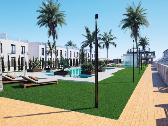 Resort pool area with palm trees, white modern villas, lounge chairs, and a yellow brick walkway under a clear blue sky.