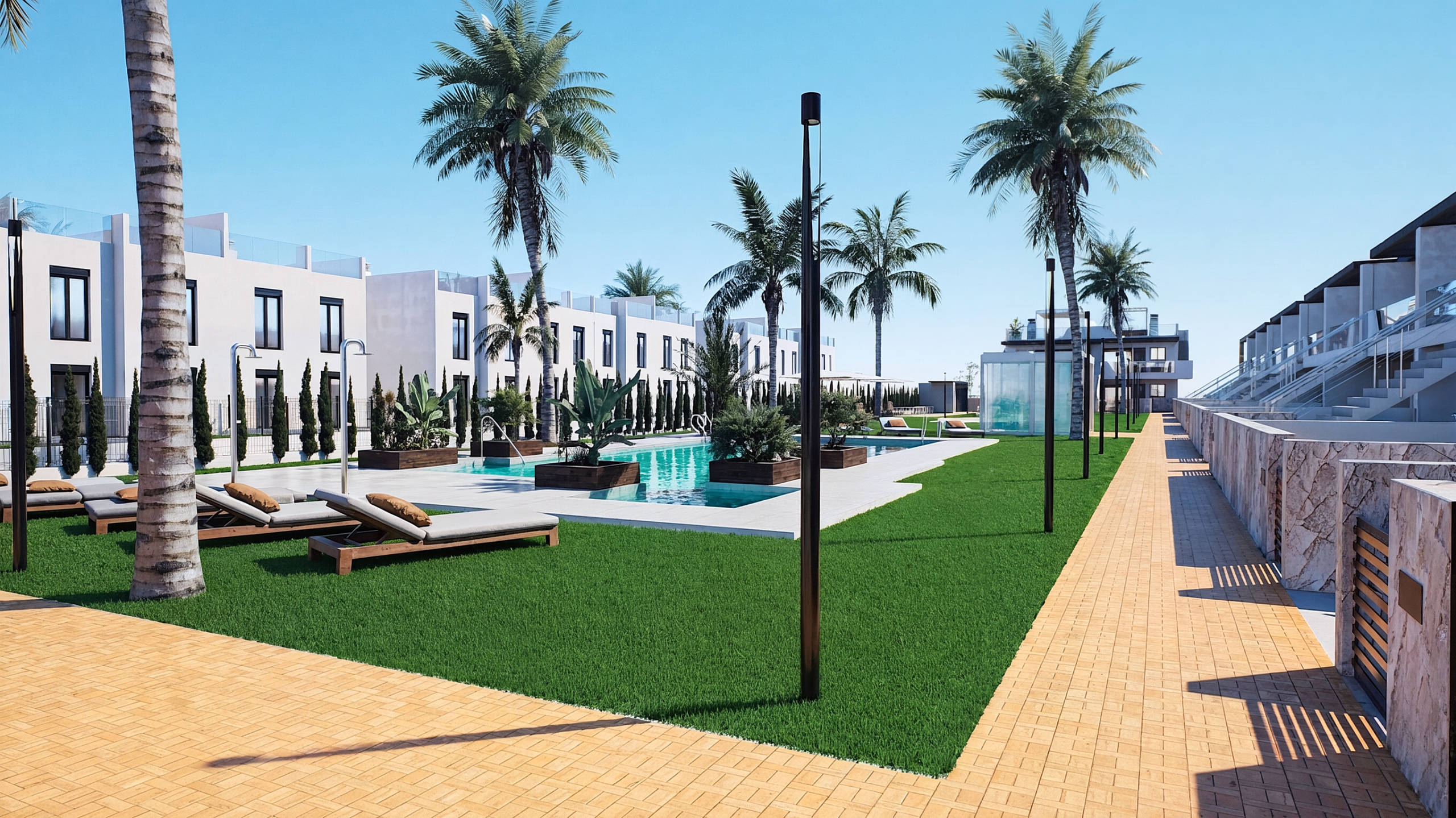 Resort pool area with palm trees, white modern villas, lounge chairs, and a yellow brick walkway under a clear blue sky.