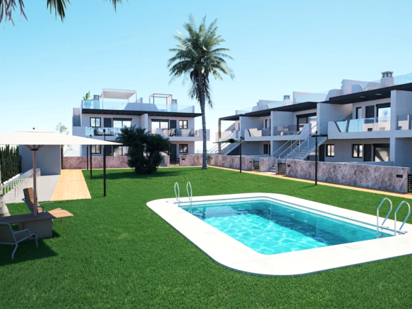 Outdoor courtyard of a modern apartment complex with a rectangular pool, green lawn, palm trees, and lounge chairs under umbrellas,