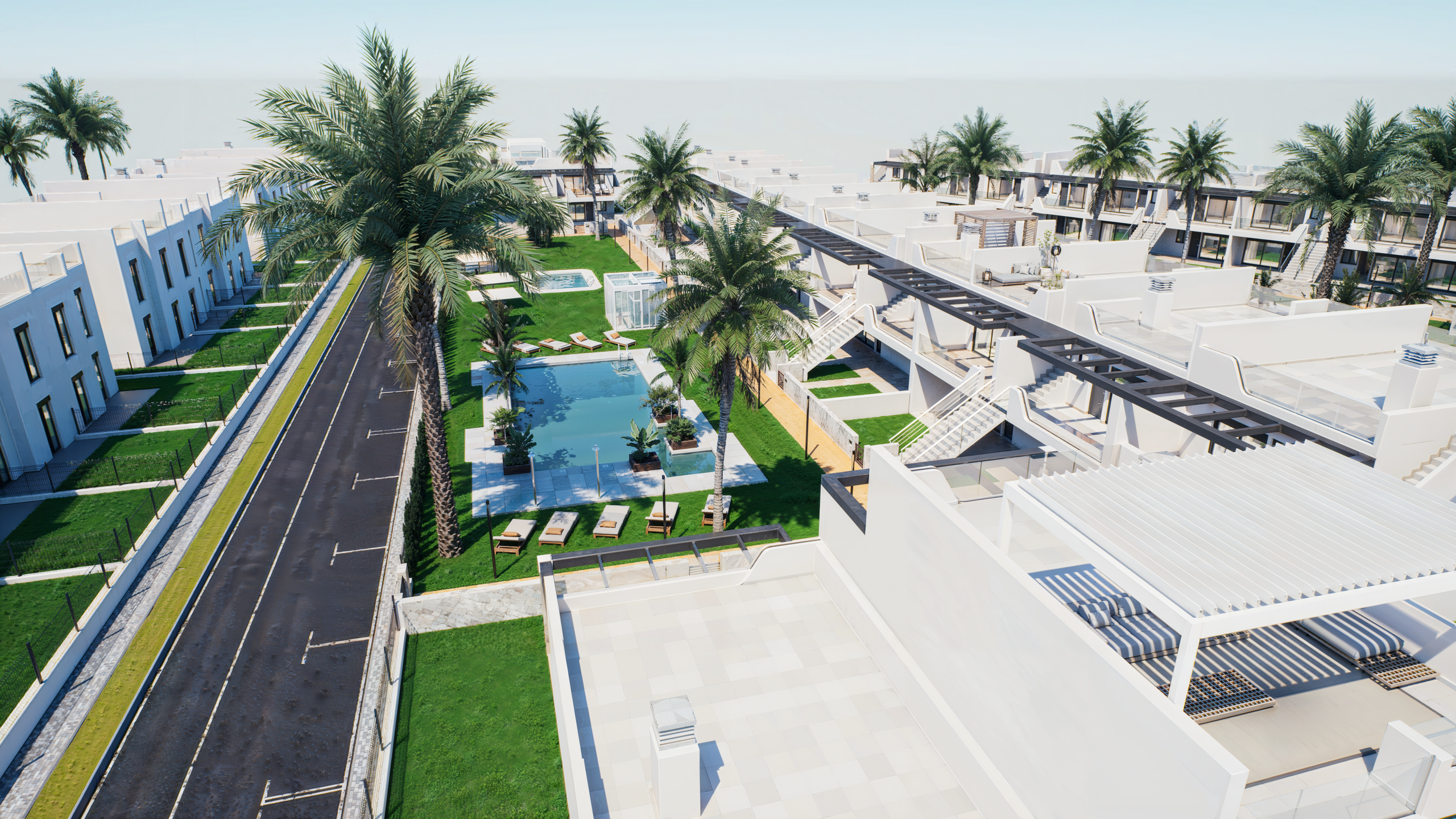 Aerial view of a modern white resort with palm trees, green lawns, rectangular pools, and walkways between buildings.