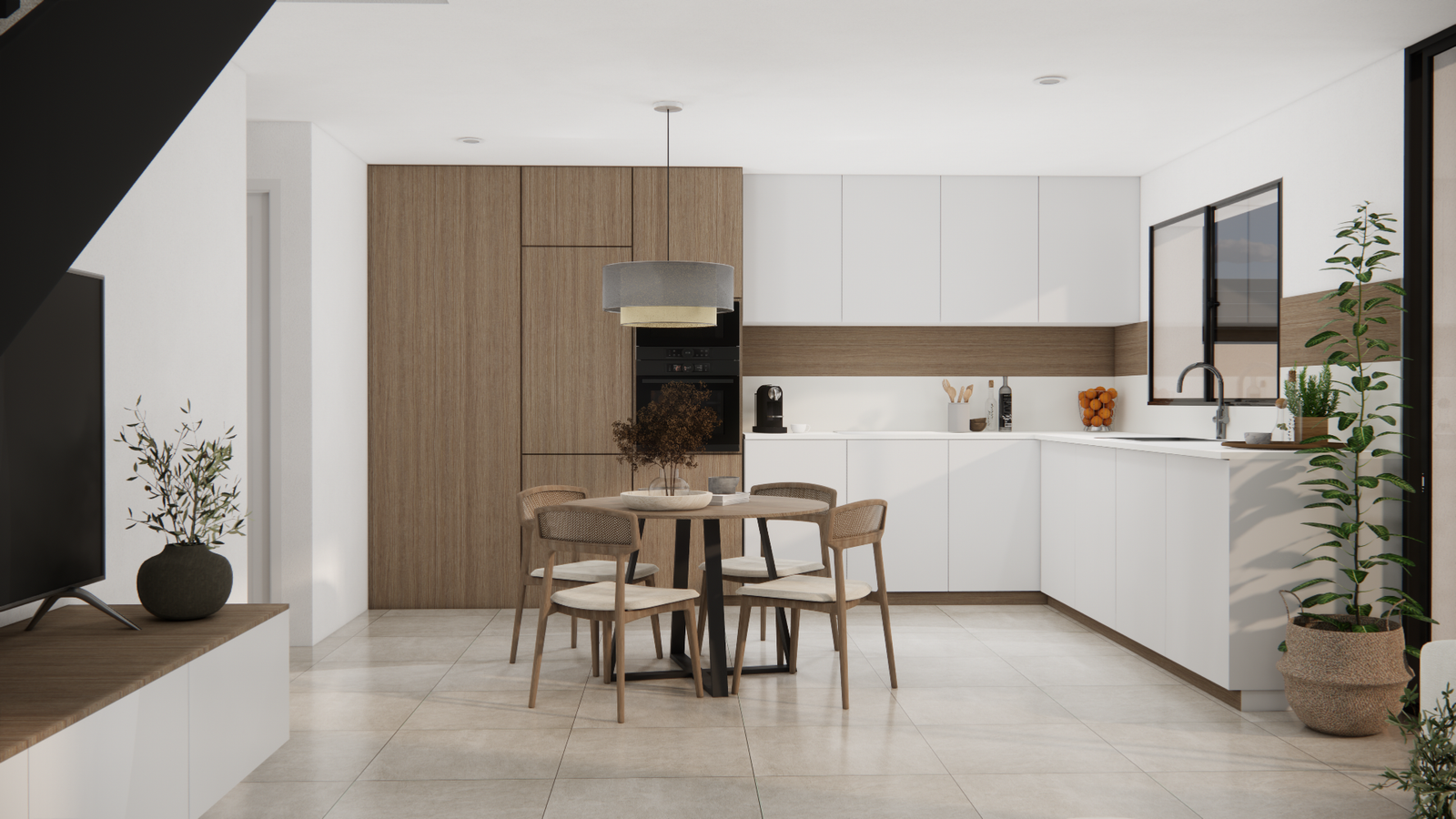 Lichte open keuken in de villa met witte kasten, houtaccenten en ronde eettafel voor vier personen.