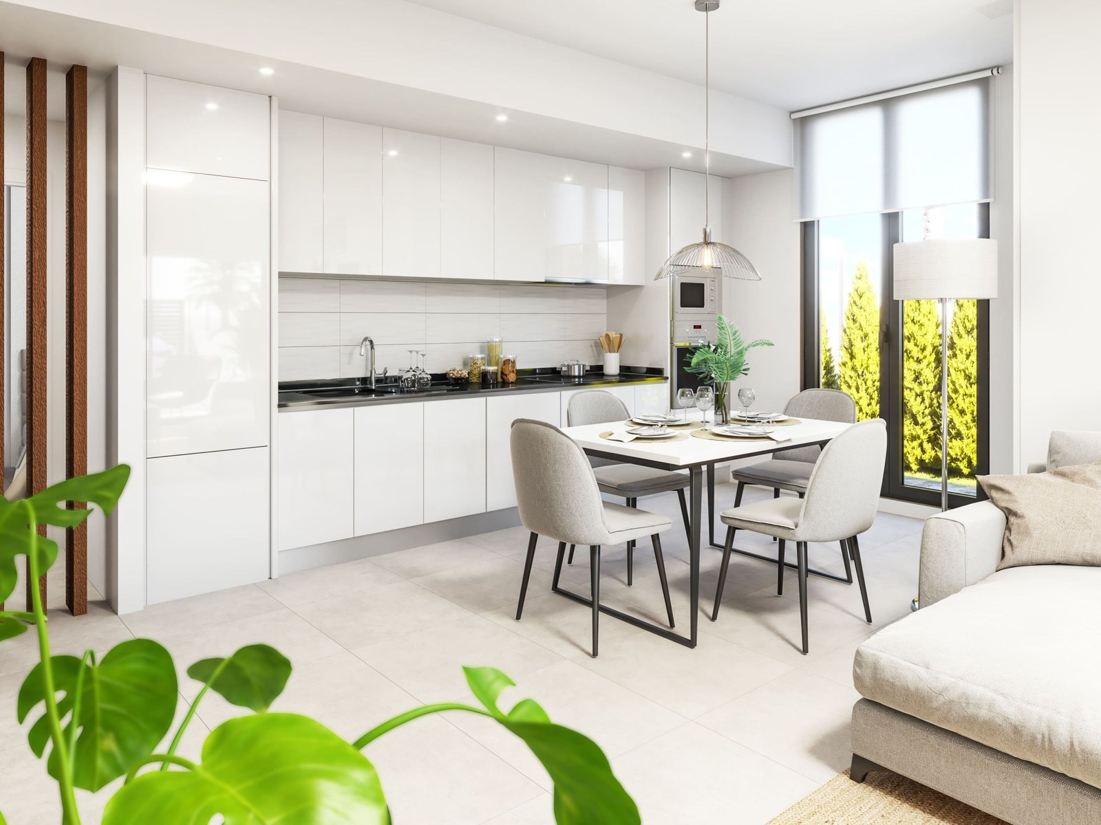 Lichte open keuken met eettafel en stoelen, met een deel van een zitbank en een plant op de voorgrond.