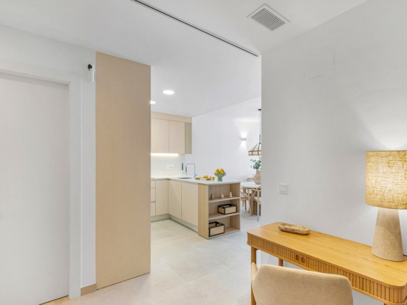 Moderne woonkamer met een bureau en een open keuken.