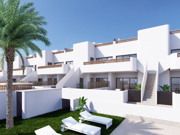 Moderne appartementen met witte gevels en een groene tuin.