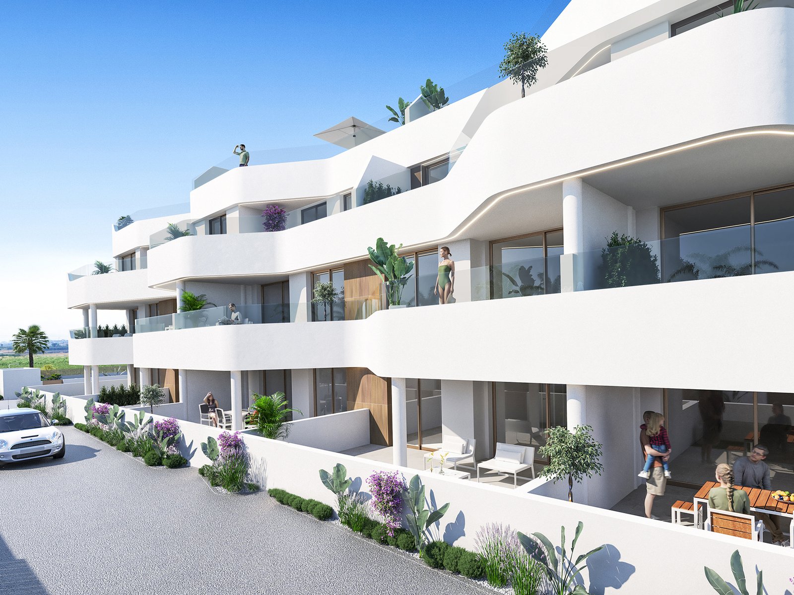Complesso residenziale moderno su più piani, con terrazze e strada di accesso.