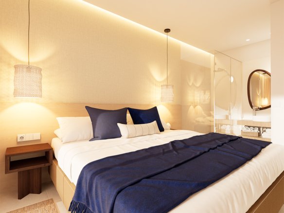 Slaapkamer met een bed en een glazen badkamerwand.