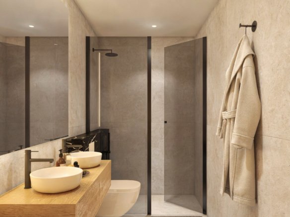Moderne badkamer met douche, wastafels en toilet.