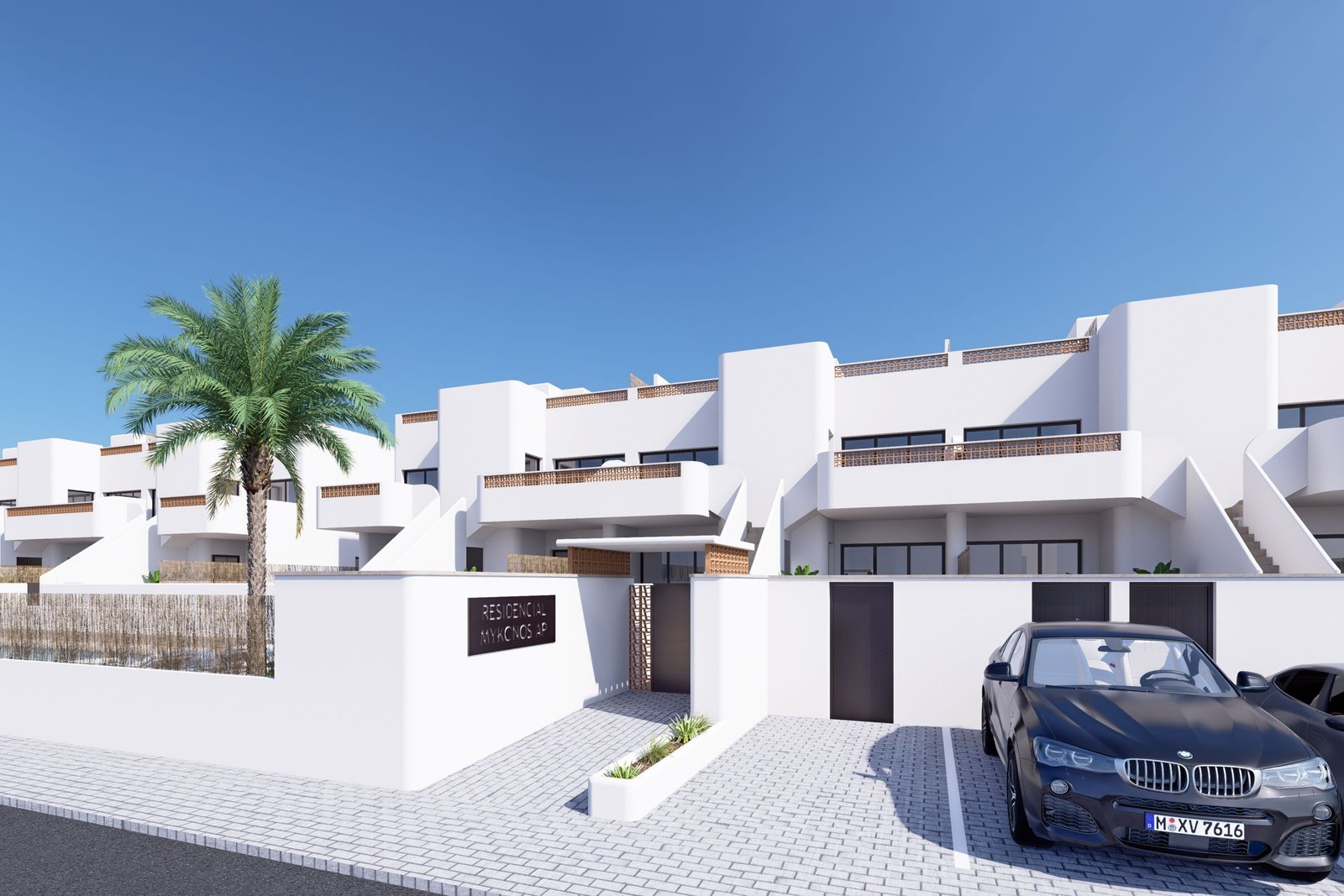 moderne huizen met wit pleisterwerk en een parkeerplaats