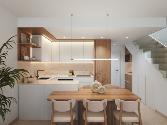 Moderne keuken met kookeiland, houten eettafel en trap.