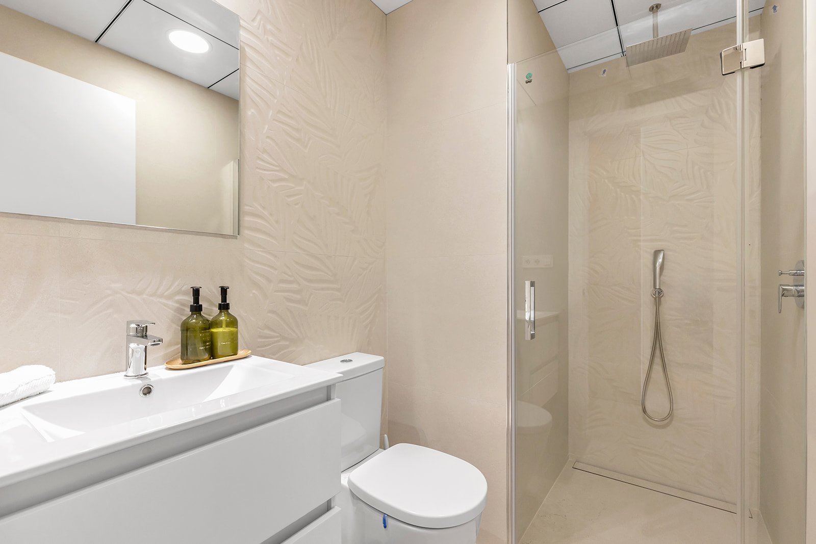 Moderne badkamer met douche, wastafel en toilet.