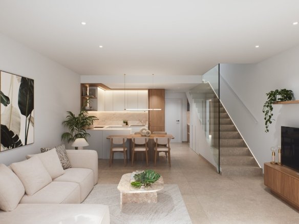 Open woonruimte met lichte zithoek, eettafel, keuken en trap met glazen balustrade.