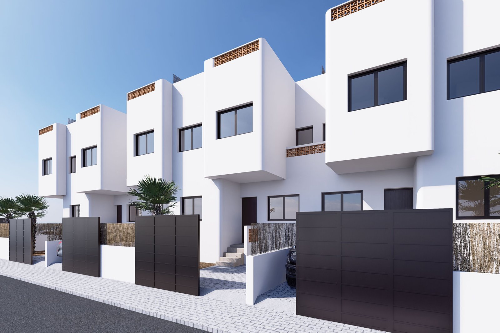 Moderne woningen met witte gevels en zwarte hekken.
